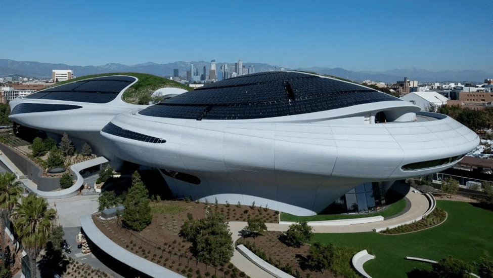 Exterior view of the Lucas Museum of Narrative Art in Los Angeles, featuring its futuristic curved architecture and landscaped grounds.